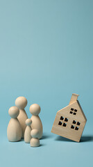 Wooden figures and house on cyan background family home