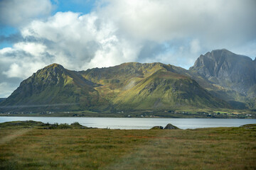 Vast Nordic Landscape: Rolling Mountains, Serene Fjord & Expansive Grasslands Under Dynamic Sky – Nature's Beauty