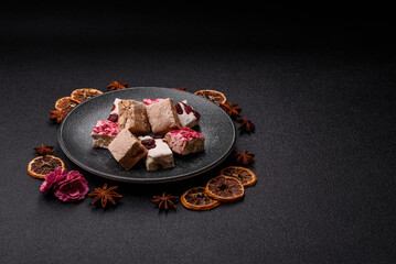 Nougat or white caramel with hazelnuts and pistachios and strawberry pieces. Nougat with nuts