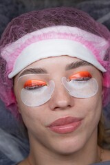 Caucasian woman undergoing eyelash lamination procedure. top view. 