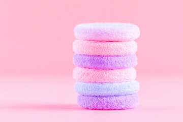 Stack of pastel pink and purple reusable makeup remover rounds eco beauty