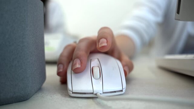 Close up of female administrator hand using mouse working on computer Technology and business concept.