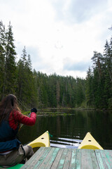 Canoeing adventure on a calm forest lake in Estonia with sunlight and scenic nature
