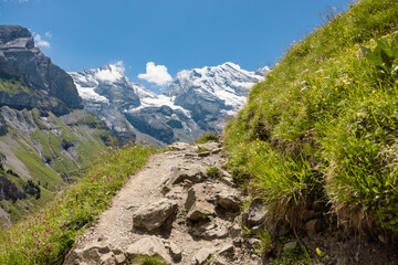 Switzerland hiking: Lake Oeschinen in Switzerland, beautiful panorama on hiking path in the swiss mountains