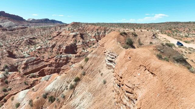 Aerial Desert Canyon Pedestal Fly Over Red Rock Landscape Road and Vehicle