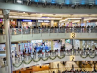defocused abstract background of several shops in the modern market in Surabaya, defocused of atmosphere of people walking in the modern market 