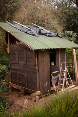 man building his own shack