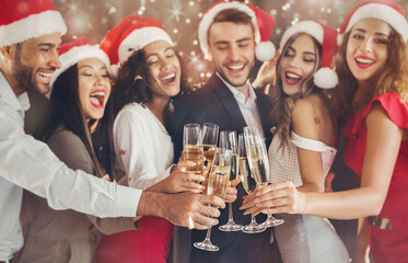 Multiethnic people celebrating New year eve, toasting with champagne flutes, cheers, hooray