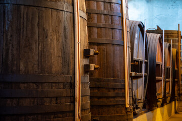 Old oak barrels for aging of natural sweet red grand cru wine Banyuls fortified dessert wine from old vines from slopes of the Catalan Pyrenees in Roussillon, France.