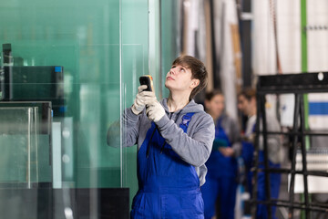 During work process, guy employee sends signal from control panel to lifting machine, moving heavy workpieces using hoist.