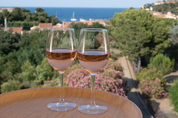 Summer vacation on Mediterranean sea, drinking cold rose wine in glass in sunlights, Collioure, Occitanie, South of France, tourists destination