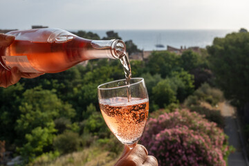 Summer vacation on Mediterranean sea, drinking cold rose wine in glass in sunlights, Collioure,...