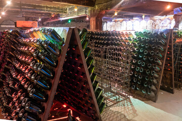 Aging and riddling of wine in champagne bottles in caves, traditional method of production of...