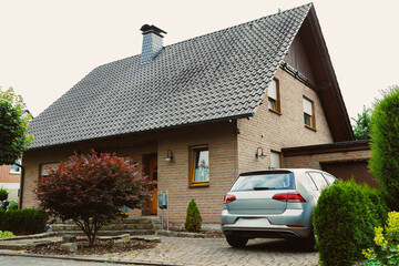 This charming residential house features a wellmaintained car parked conveniently on the driveway...
