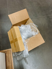 The shipping box contains tightly wrapped plastic that effectively ensures the items inside are wellprepared, safe, and protected during both shipping processes and storage periods