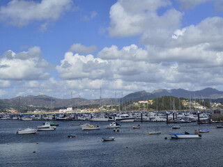 Water cycle: The bay of Baiona with pleasure boats at anchor and cumulus and stratocumulus clouds...