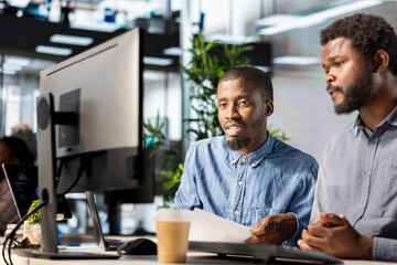 Entrepreneur meets with his team member to share insight on startup goals, focusing on...