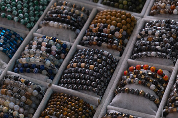 Colorful collection of handmade bracelets displayed at a local craft market during a sunny afternoon
