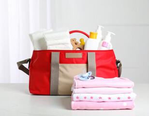 Red Diaper Bag with Baby Clothes and Essentials
