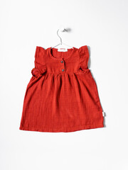 Baby cotton dress for girl with hanger. Clothing production, sewing workshop