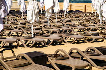 Sunny summer beach on the Baltic Sea in Sopot. Lounge chairs and parasols