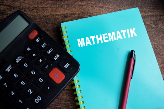 Concept of Mathematik write on book isolated on Wooden Table.