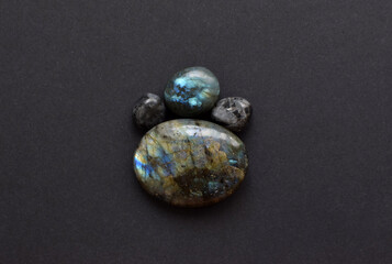 Beautiful natural labradorites with iridescence   a dark gray background. Healing crystals,...