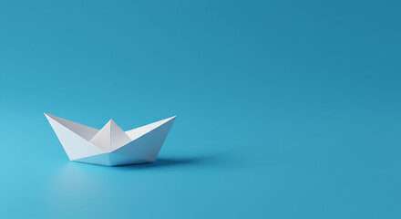 Obraz premium Paper boat on blue background, minimal and metaphorical composition