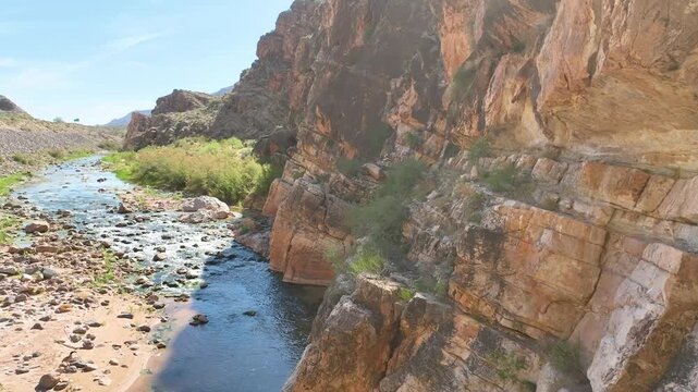 Aerial River Gorge Cliffs and Desert Vegetation Fly Through Forward Motion