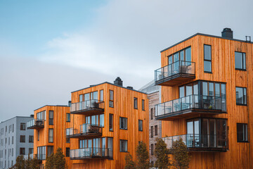 Fototapeta premium closeup shots of contemporary wooden facades of buildings featuring unique designs