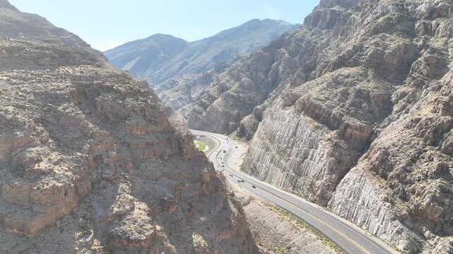 Aerial Winding Highway Through Desert Canyon With River Gorge Fly Through Motion