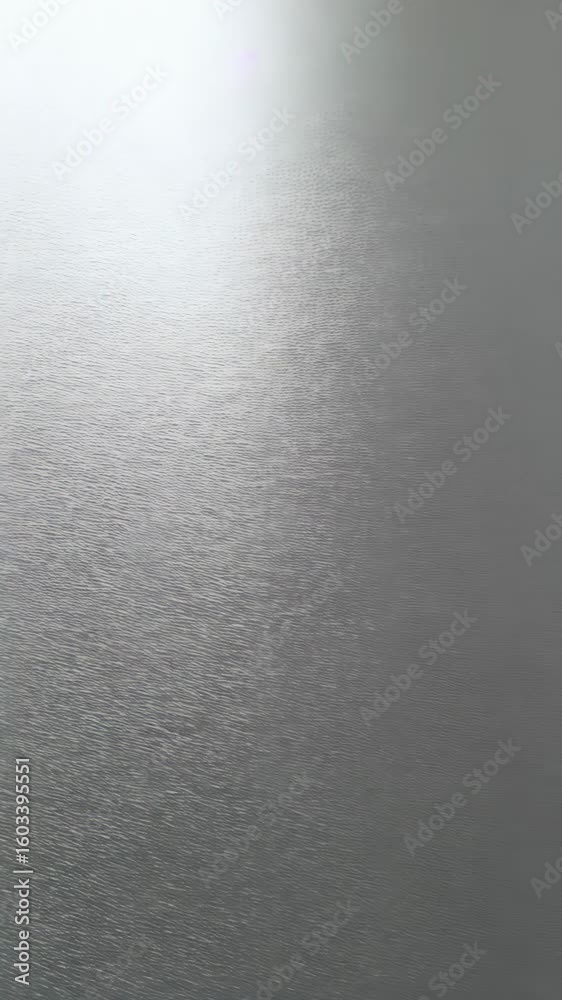 Poster abstract shimmering light reflecting off textured metal surface, creating a gradient from white to g