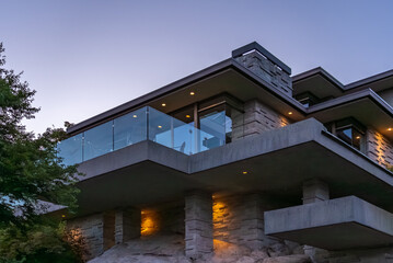 Two story stucco luxury house with nice Spring blossom landscape at night in Vancouver, Canada, North America. May 2025.