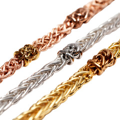 Obraz premium Elegant close-up of three exquisite woven metal chains showcasing intricate craftsmanship