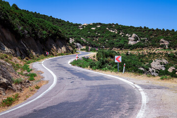 Winding mountain road with traffic signs