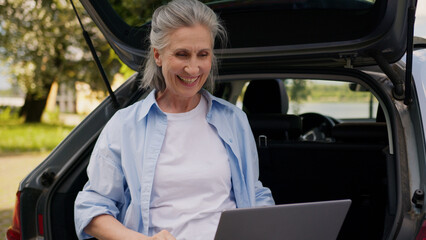 Happy positive Caucasian mature elderly business woman senior female freelancer aged businesswoman...