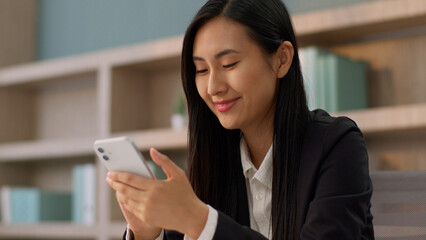 Smiling positive Asian Japanese girl office worker secretary business woman joyful Korean female...