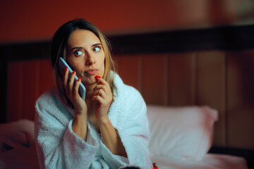 Puzzled Woman Talking to the Phone in her Bedroom. Pensive girlfriend chatting on the mobile with...