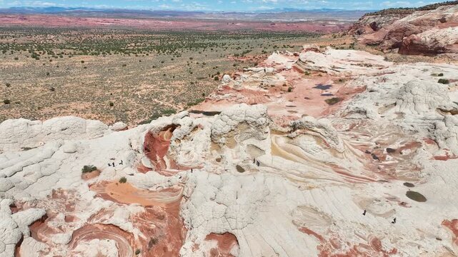 Aerial White Pocket Rock Formation Arc Shot with Dramatic Desert Landscape