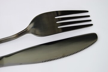 Sleek Silverware Fork and Knife Duo on White Backdrop Minimalist Kitchen Still Life.