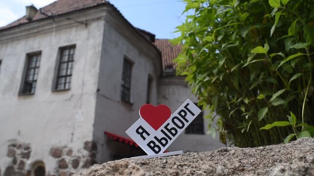 Souvenir "I love Vyborg" (Russian language) in front of the Church of St. Hyacinth (formerly) or the Knight's House, built in the 16th century in the city of Vyborg, Leningrad region, Russia.