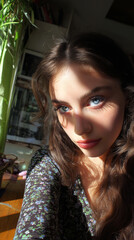 Stunning close-up portrait of a young caucasian woman with blue eyes in natural sunlight