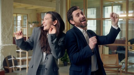 Funny business man woman dancing celebrating music party at office success deal Caucasian Korean entrepreneurs businesswoman businessman dance active moving listen song rhythm singing happiness job