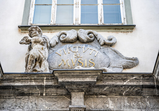 Detail of the Baroque cartouche inscribed with the Latin motto "Virtuti & Musis" above the main entrance of the Seminary Palace in Dolnicarjeva ulica, Ljubljana.