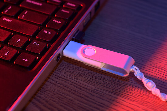 USB drive plugged into the side of a laptop