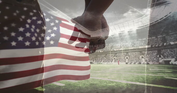 Holding hands, silhouetted couple walking on stadium turf sideline, with American flag overlay - Powered by Adobe