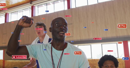 Raising fist coach motivating players in gymnasium, with jerseys whistle Play Subscribe Like icons