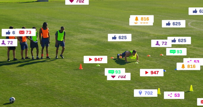 Crawling athlete, teammates in bibs doing soccer drill on soccer field, with social media icons