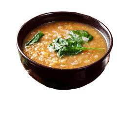 Nutritious barley soup with fresh spinach in a brown bowl isolated on black background