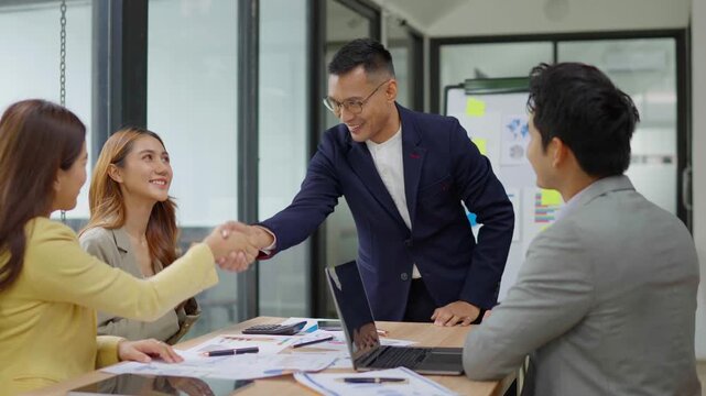 Asian business group is happy to join hands to show success in their careers.	
